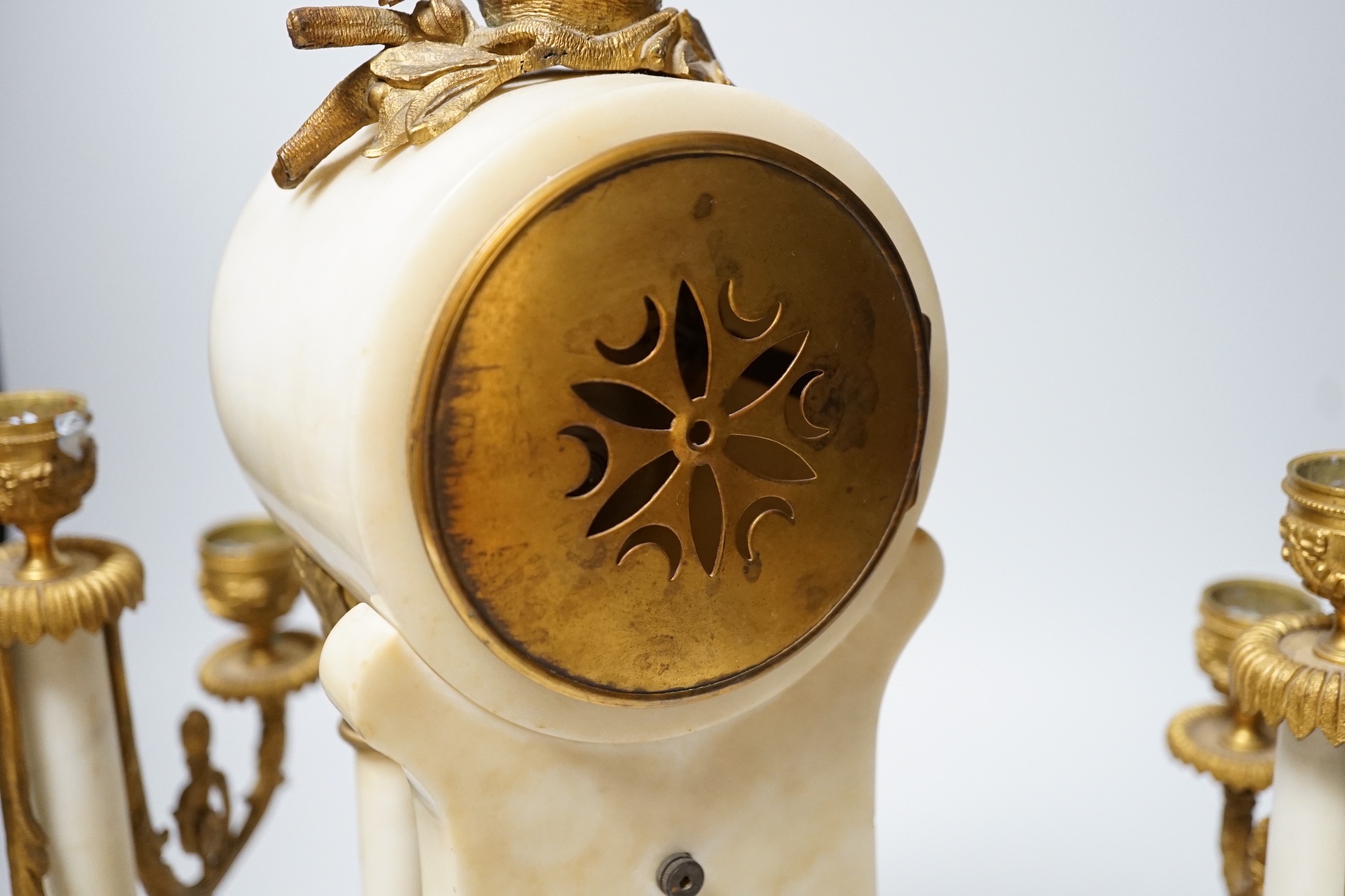A 19th century alabaster clock garniture, French movement count-wheel striking on a bell, clock 34cm